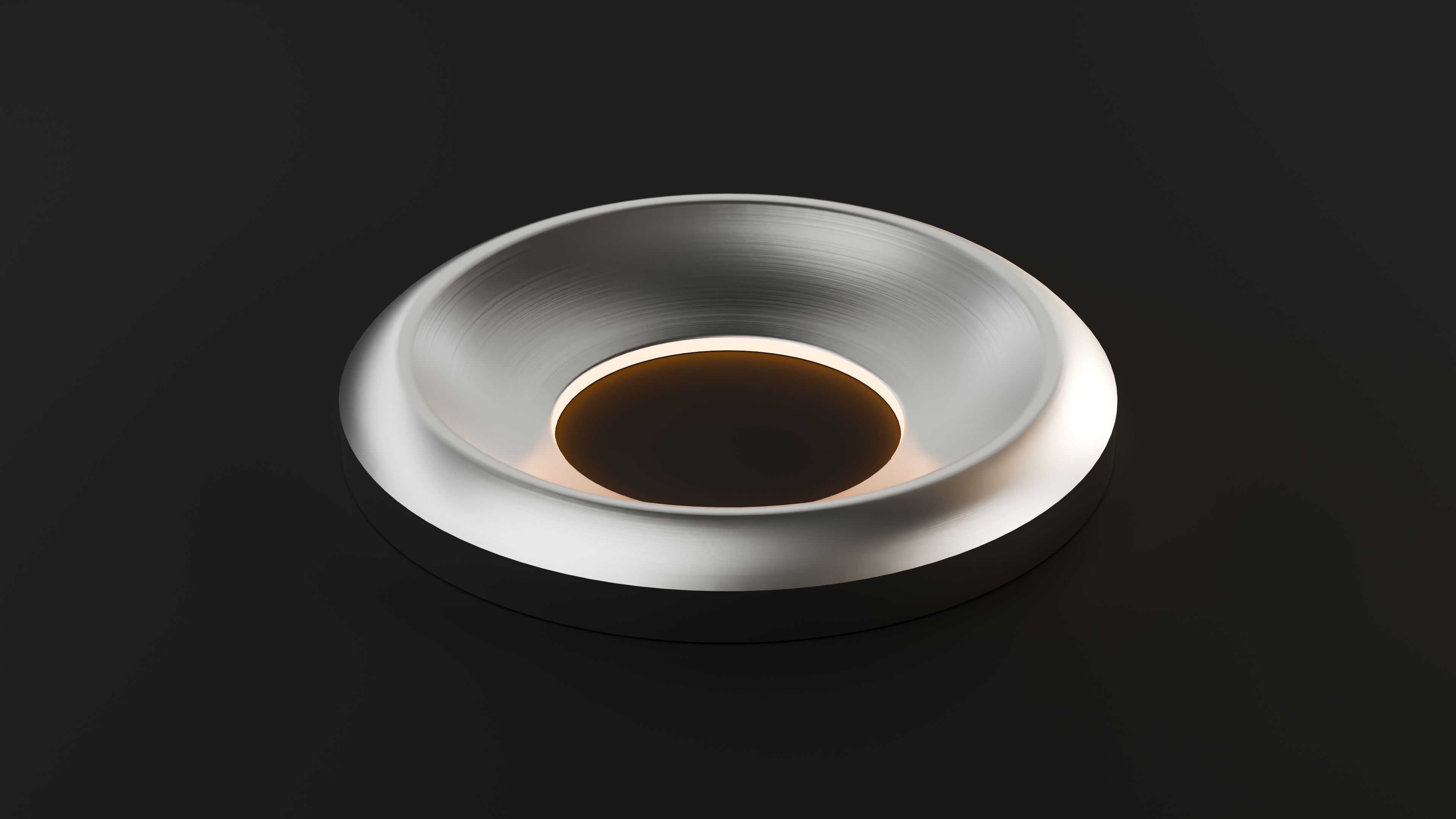The device from above, glowing amber at the centre
